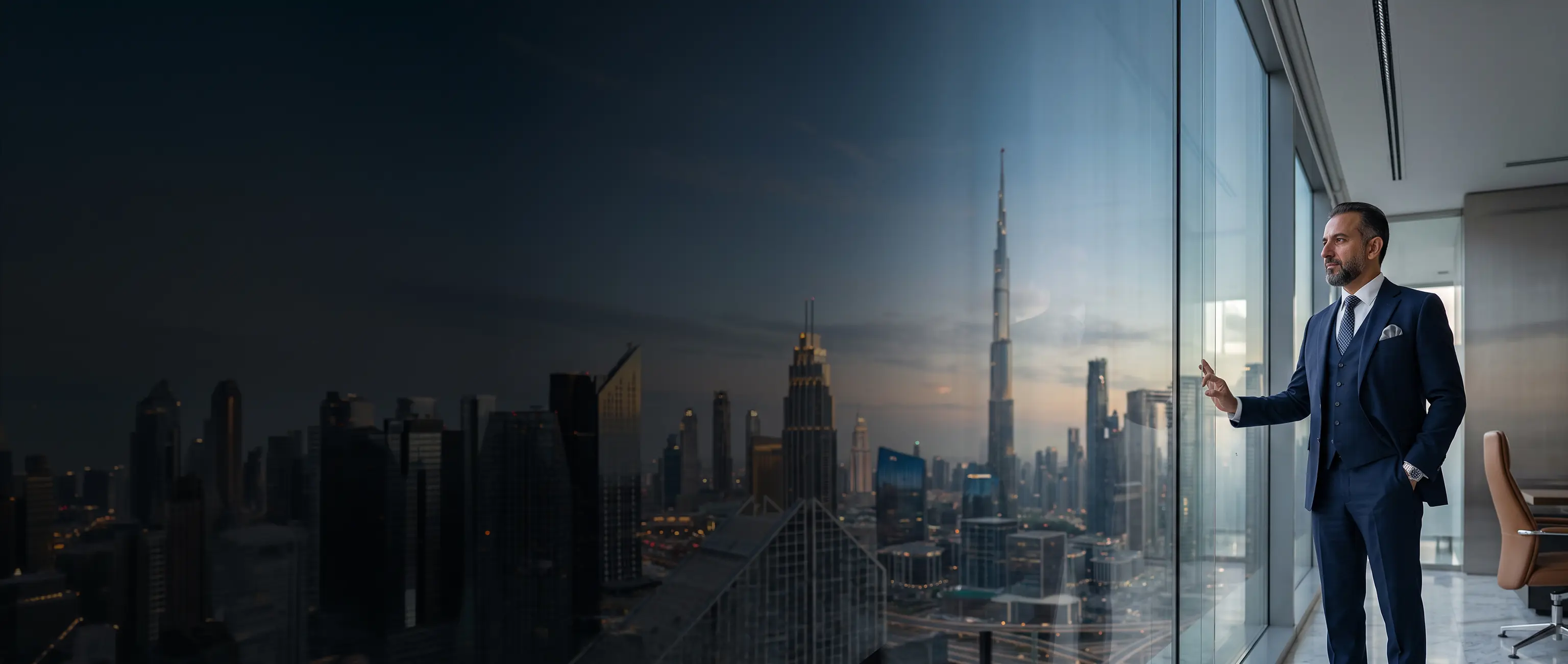 A professional corporate leader looking thoughtfully at the Dubai skyline from a modern high-rise office, representing strategic financial vision and premium Treasury Solutions for businesses by National Bonds.